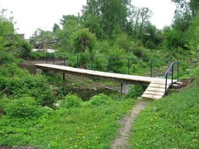 Пешеходный мостик рядом с улицей Некрасова и Театральной через пересыхающую в жару речку Сергачка города Сергач